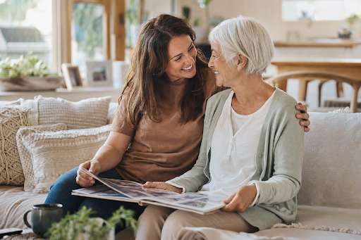 Photo of daughter and elderly mum together in a warm home setting